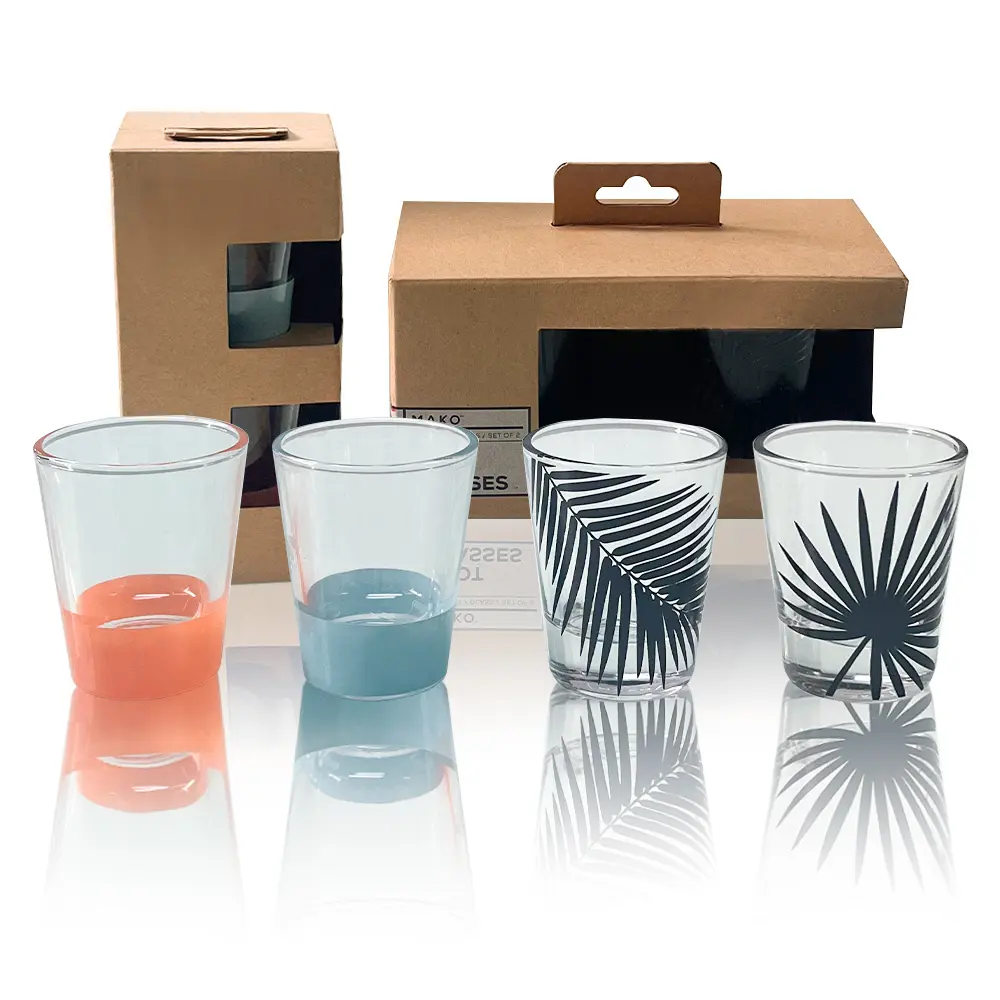 Set of 4 creative glass shot glasses featuring bottom gradient colors and black tropical plant leaf prints