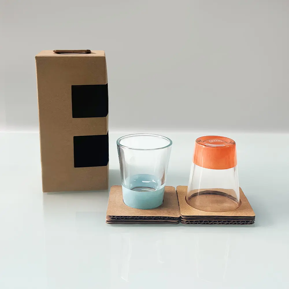Modern minimalist barware, clear glass cups with coral orange, sky blue bases, and palm leaf decorative patterns