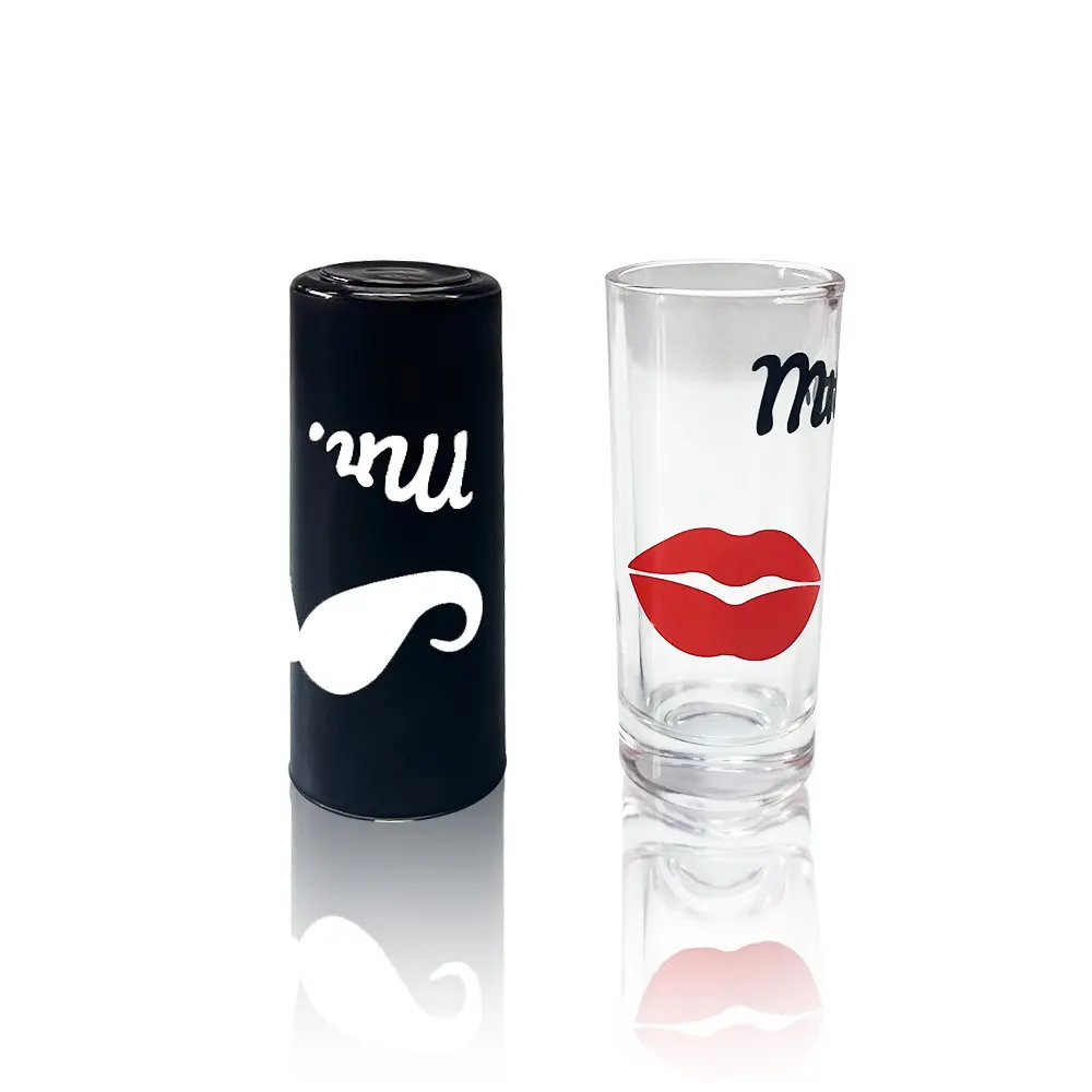 Romantic Couple Shot Glass Pair Black opaque "Mr." shot glass and clear transparent "Mrs." shot glass featuring fun couple icons.