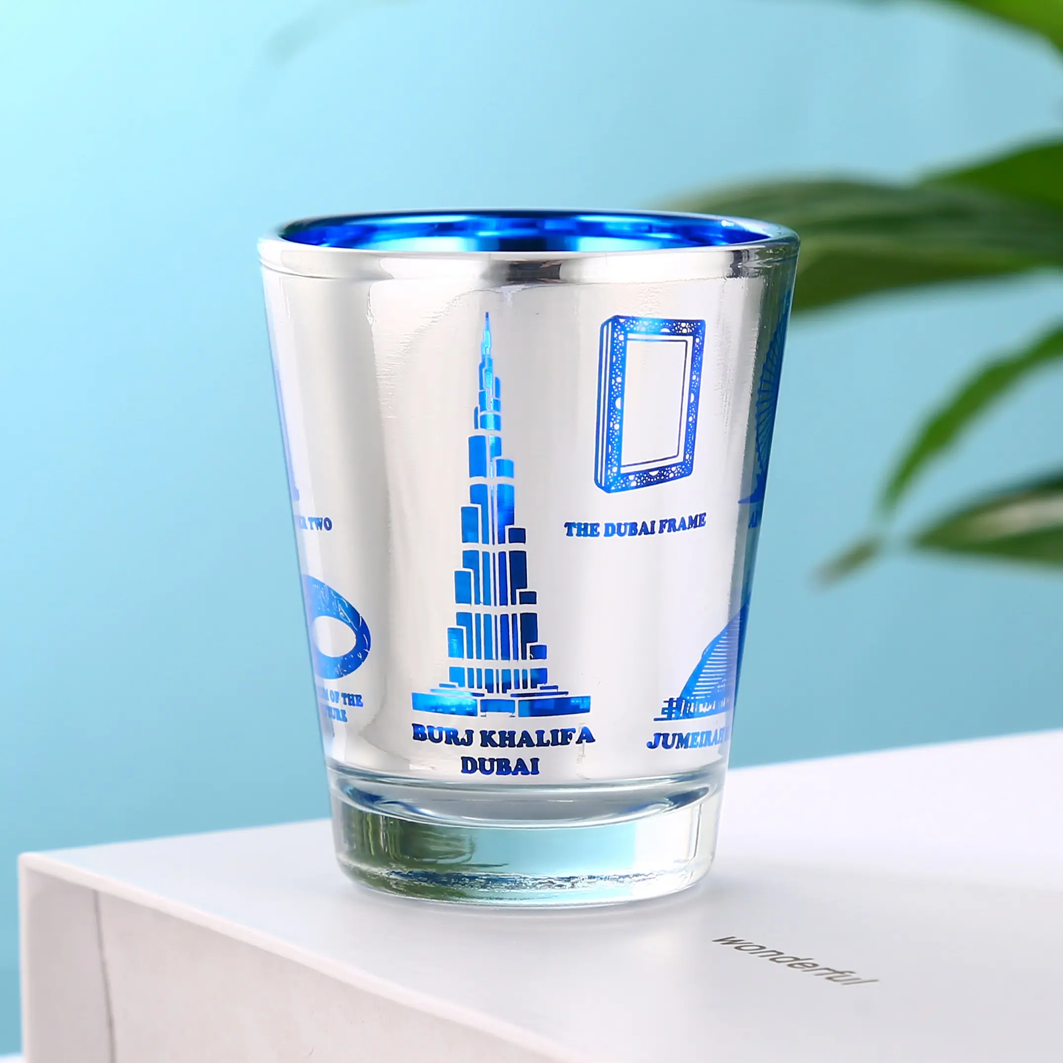 Blue electroplated Dubai souvenir shot glass styled for lifestyle display