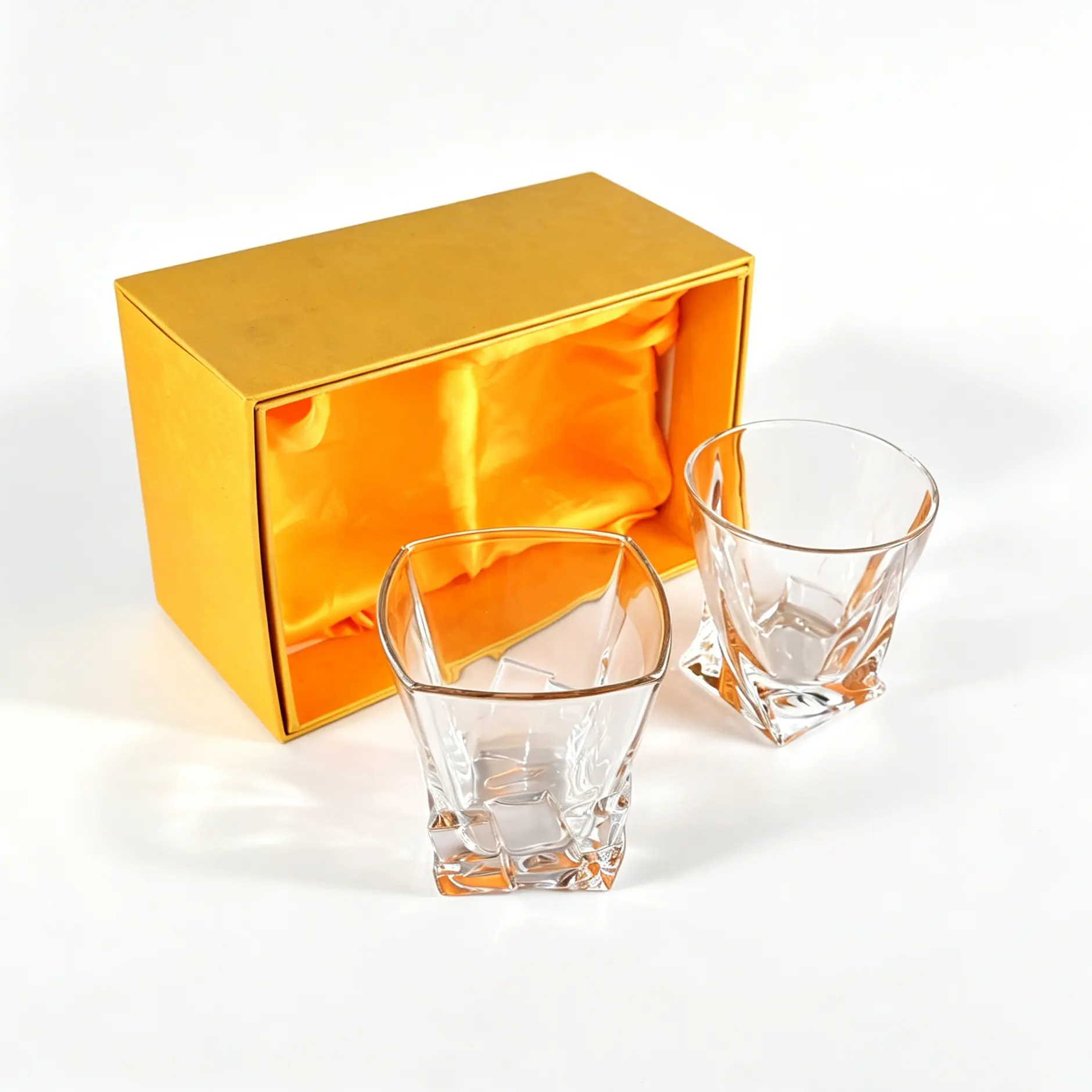 Two crystal whiskey glasses with a luxury gold gift box.