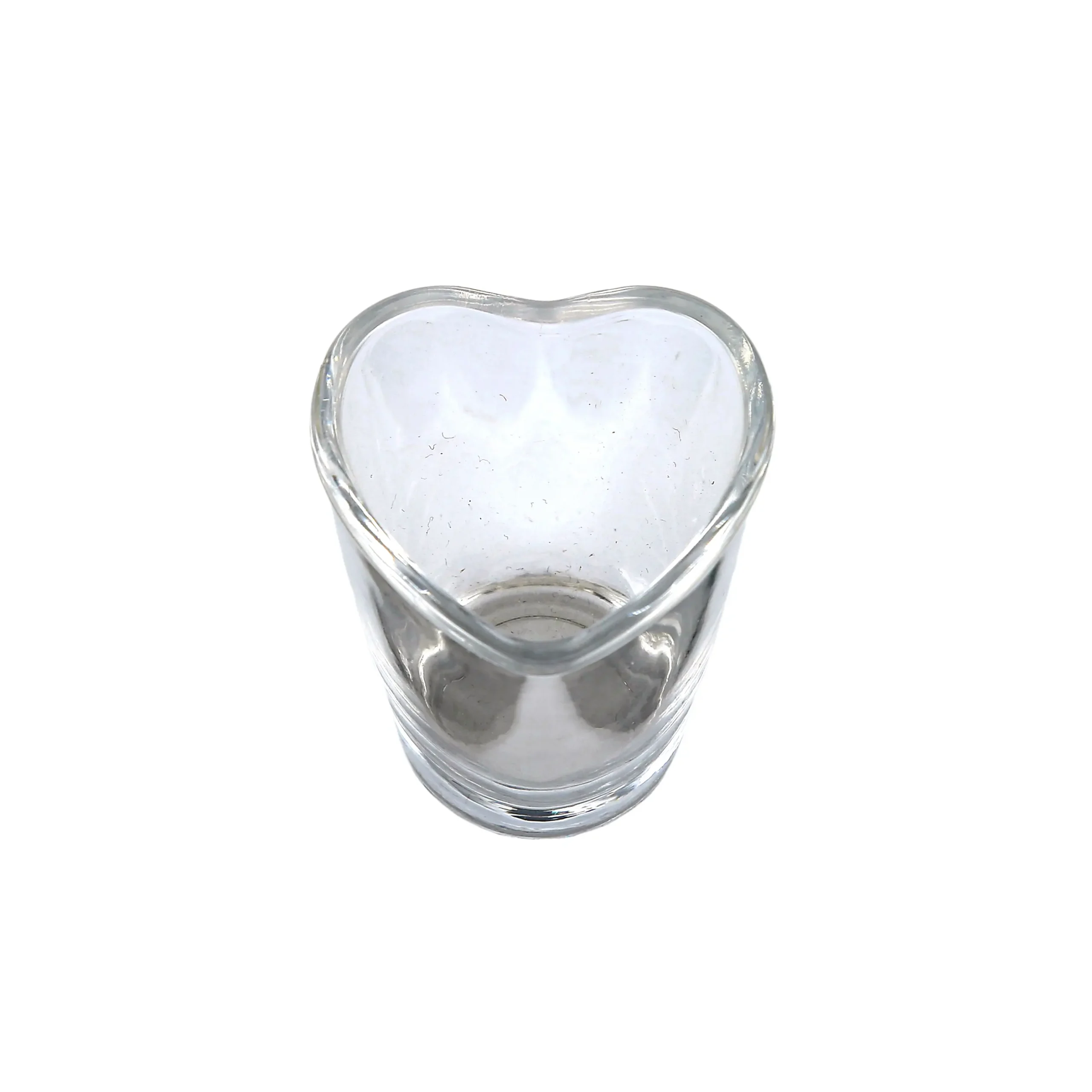 Top view of a transparent heart shaped shot glass with a smooth rim, perfect for serving vodka or whiskey.