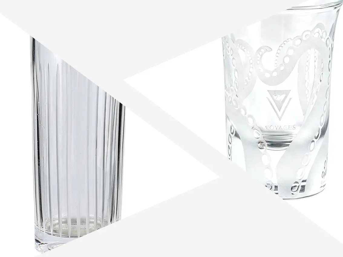 Custom glassware with precise laser engraving logo and detailed engraved pattern.