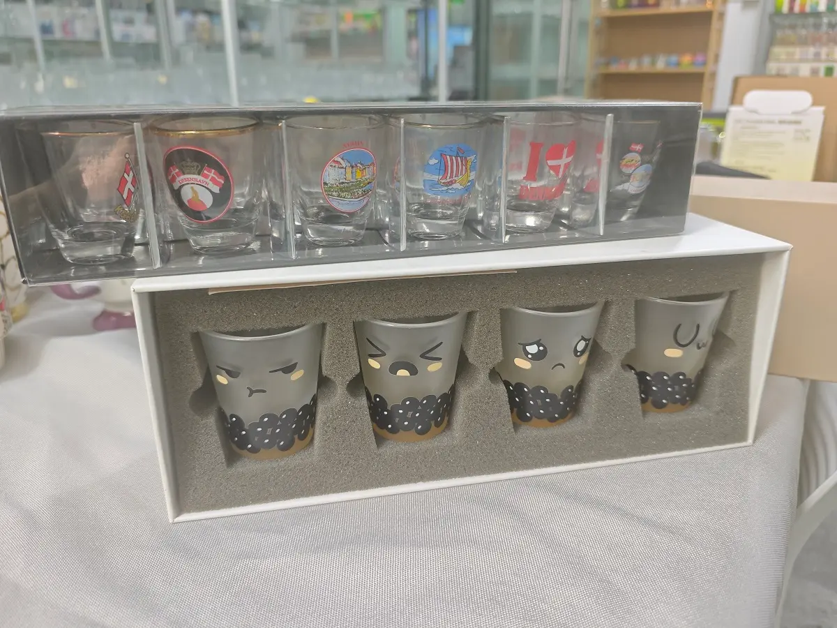Custom printed retail souvenir shot glass sets displaying retail gift box packaging and anti-breakage protective foam inserts for B2B orders.