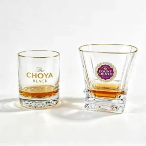 Custom branded whiskey glasses with printed company logo for wholesale orders.